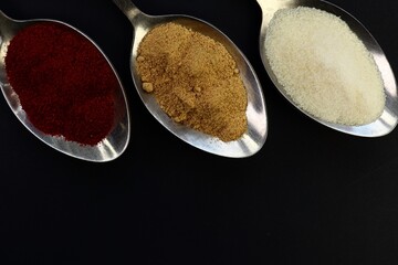 salt and pepper on spoon