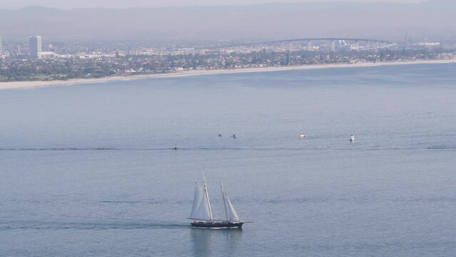 San Diego city skyline, cityscape of downtown with highrise skyscrapers, California coast, USA. View of Coronado island from above, Point Loma vista viewpoint. Frigate sail-powered ship, windjammer.