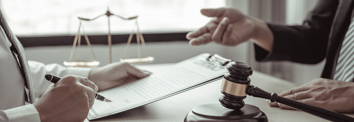 Lawyer or judge has recommend a client sign a legal agreement in the courtroom, Legal Agreement Documents and Business Litigation Forms, scales of justice, law hammer, Litigation and legal services.