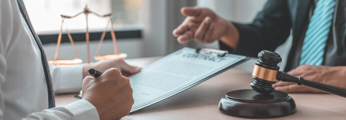 Lawyer or judge has recommend a client sign a legal agreement in the courtroom, Legal Agreement Documents and Business Litigation Forms, scales of justice, law hammer, Litigation and legal services.