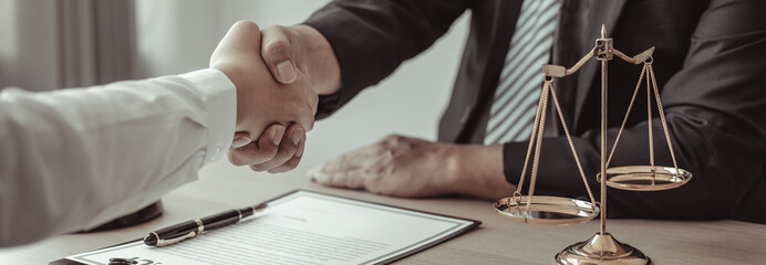 Businessman shaking hands with a lawyer or judge After signing the contract and the agreement is complete, Approval of an agreement between business and law, End of the legal case. - obrazy, fototapety, plakaty