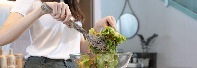 Asian woman making vegetable salad in her home kitchen, Vegetables contain a wide variety of vitamins and minerals, High-fiber and low-calorie diets, Healthy vegetable salad idea, Appetizer concept.