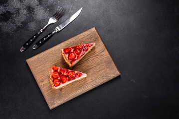 Delicious strawberry tart on concrete background, top view, copy space