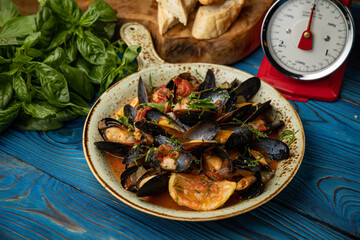 delicious seafood stew with mussels on wooden table