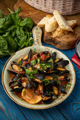 delicious seafood stew with mussels on wooden table
