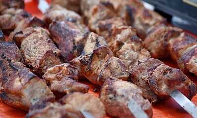 barbecue on skewers is cooked on the street in summer