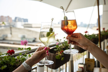 woman with cocktail in hand on a bar counter