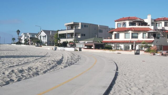 Beachfront houses on waterfront walkway, ocean beach in California, USA. Holiday, vacations or weekend rental homes on sea coast near Los Angeles. Waterside property on shore, Mission beach, San Diego