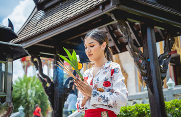 Beautiful Asian girl at big Buddhist temple dressed in traditional costume