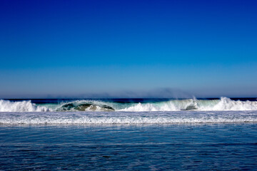 Waves in the ocean with blue sky