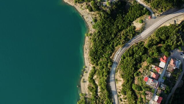 Top down drone shot of lake with turquoise water and coastline. Lake Kremaston (or Kremasta) in Evritania region, Central Greece.