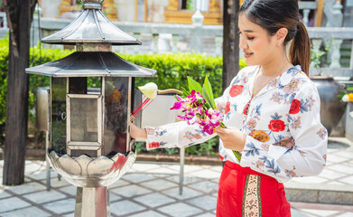 Beautiful Asian girl at big Buddhist temple dressed in traditional costume