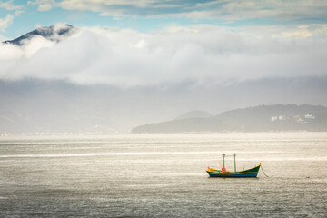 Obraz premium Bay with fishermen boat in Jurere beach at sunset Florianopolis, Brazil