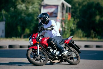 Moto school track driving. A biker on a motorcycle.
