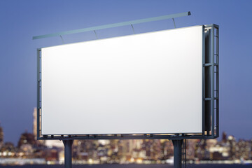 Fototapeta premium Blank white billboard on cityscape background at evening, perspective view. Mock up, advertising concept