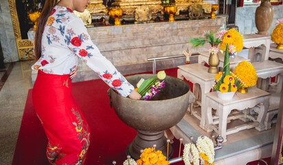 Beautiful Asian girl at big Buddhist temple dressed in traditional costume