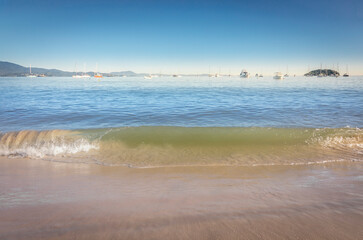 Boats and sailboats in Jurere Internacional beach at sunset Florianopolis, Brazil