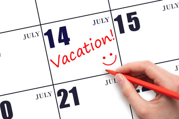 A hand writing a VACATION text and drawing a smiling face on a calendar date 14July. Vacation planning concept.