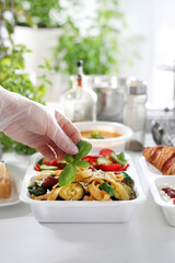 Dietary catering. pasta with zucchini, sun-dried tomatoes and spinach. Meal prep.