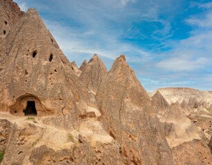 Fototapeta na wymiar Cave dwellings, fairy chimneys and landscape of Cappadocia, Goreme National Park of Nevsehir, Turkey.