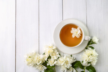 Fototapeta na wymiar Jasmine tea in a cup on a wooden background. Copy space