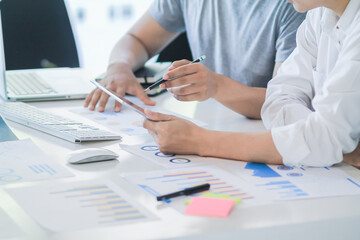 group of startup entrepreneurs who are investing together are studying marketing and planning their...