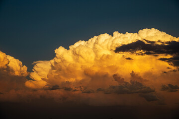 Thunderhead clouds form over the residential area during the summer evening