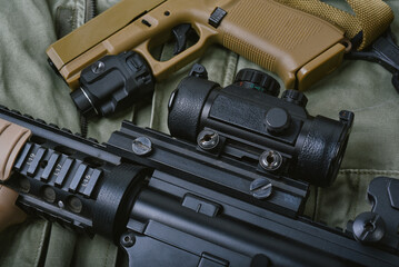 Weapons and military equipment for army, Assault rifle gun (M4A1) and handgun 9mm on green khaki...