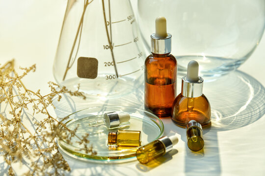 Natural skincare beauty products, Organic botany extraction serum oil and scientific laboratory glassware, Blank label cosmetic spa container for branding mock-up.