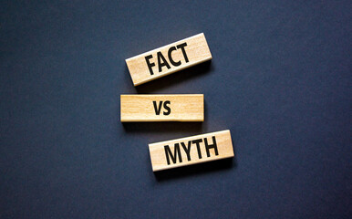 Fact vs myth symbol. Concept words Fact vs myth on wooden blocks on a beautiful black table black background. Business, finacial and fact vs myth concept. Copy space.