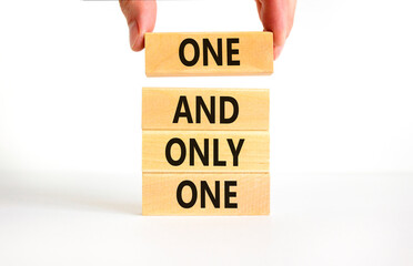 One and only one symbol. Concept words One and only one on wooden blocks on a beautiful white table...