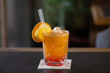 Squeezed orange juice with ice cubes in a glass