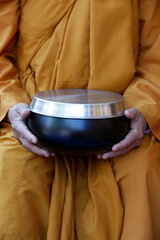 Buddhist nun holding her alm bowl