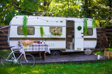 bicycle in the garden near the house on wheels, camp trailer. recreational vehicle.