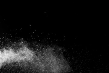 Horizontal steam with drops of spray flying in different directions on a black background for overlay on a photo. Stream, jet of hot water with steam and drops.