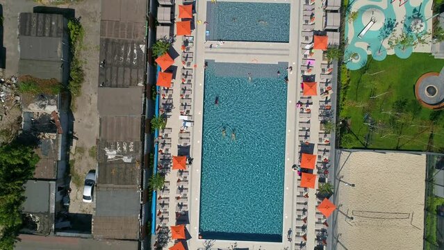 Drone aerial top view people swim in the pool on the territory modern Residential complex Faina Town. Construction of residential premises. Kyiv capital of Ukraine