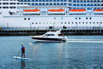 Transportation  ferry cruise passenger and people canoeing in Alesund, Norway.