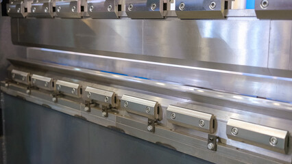 Close-up opening of large stainless industrial machine. Motion of a big great metal parts.