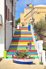 Colored staircase that leads from the town to the old port. Lampedusa, Italy  - August 2019