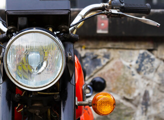Fototapeta premium Headlight of a standing motorcycle close-up.