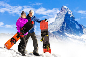 family and snowboard on snowy mountain