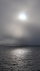 Sunrise over the sea. Sun shining through clouds and fog. A view at pacific ocean from BC ferries Canada. 
