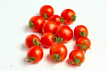 Cherry tomato group, ripe organic tomatoes on a light background