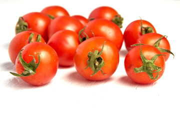 Cherry tomato group, ripe organic tomatoes on a light background