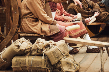 A man in vintage medieval clothes with a paper letter in his hand. Reconstruction of the events of the Middle Ages in Europe