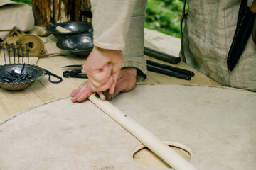Making medieval shields made of wood and leather to protect soldiers in war. Reconstruction of the events of the Middle Ages in Europe.