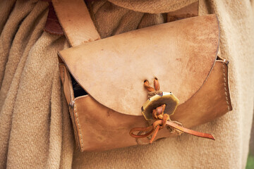 Vintage leather waist bag on a man in ancient roman retro clothes.