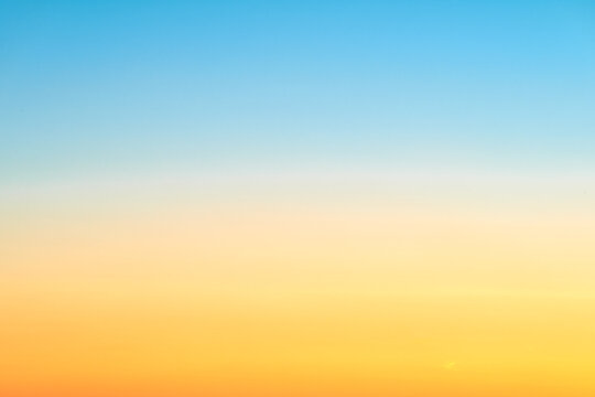 Sunrise orange-blue sky gradient, clear sky without clouds. Beautiful red and light blue sky, copy space for text