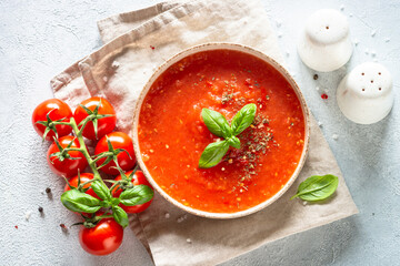 Tomato soup. Traditional vegetable soup. Top view on white background.