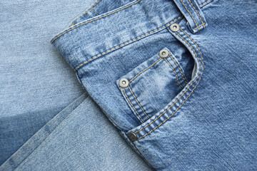 Fototapeta premium Lots of jeans pants in a stack. Denim background.
